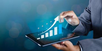 Graph of financial growth global communications Binary Smart Phones and world Internet Business people press the phone to communicate in the Internet Stock chart Researching process.business Team Working Startup modern office Laptop global strategy virtual Icon.Innovation graphs Interfaces